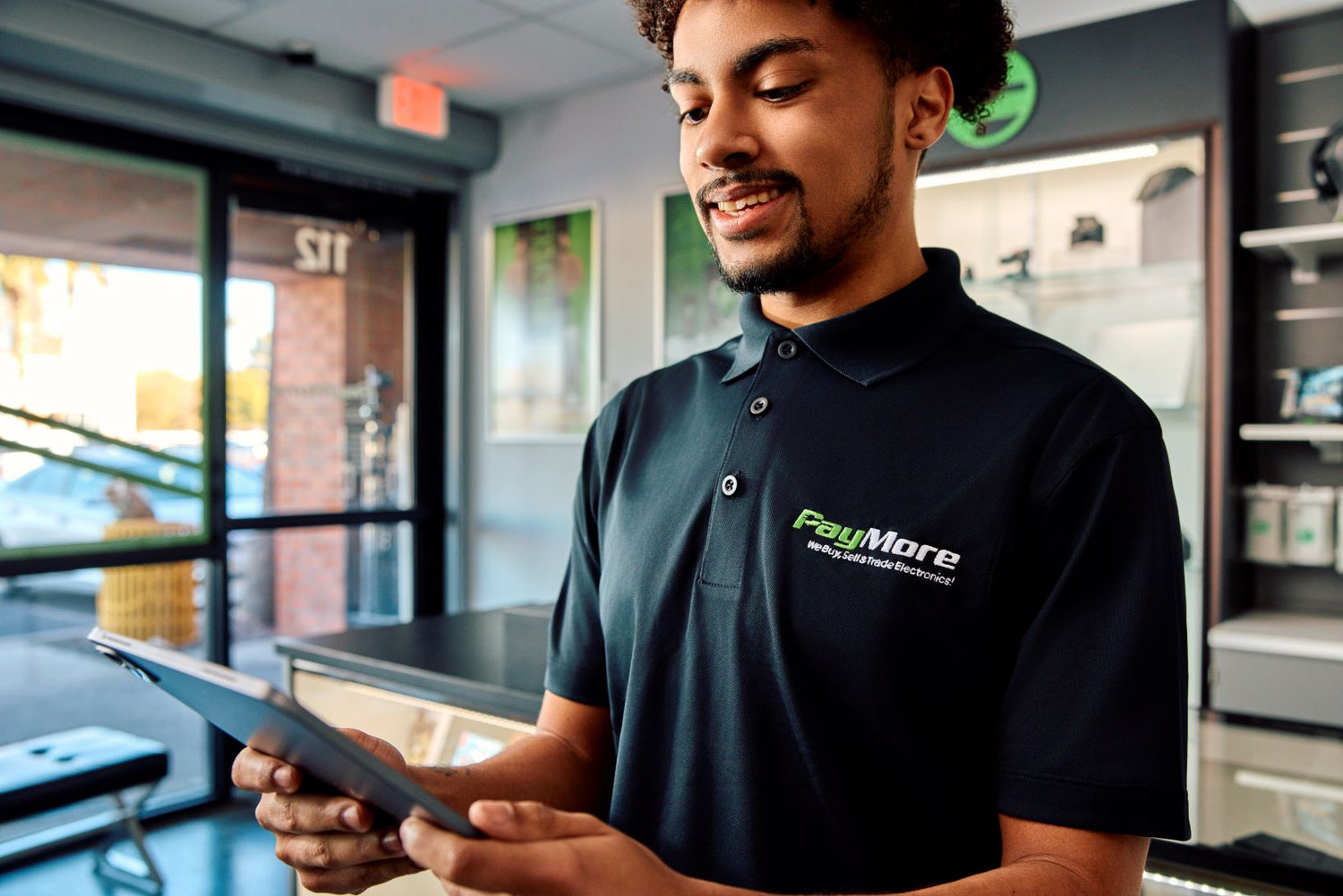 paymore employee holding a tablet and smiling